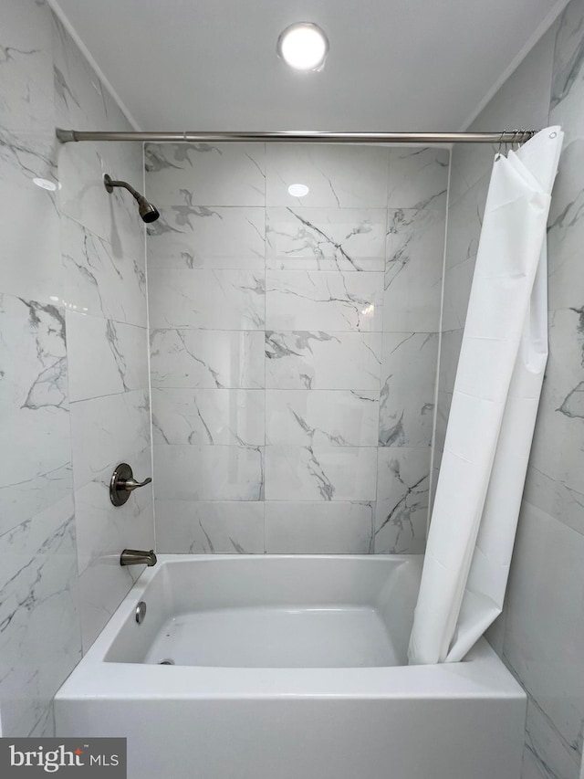 bathroom with shower / bath combination with curtain