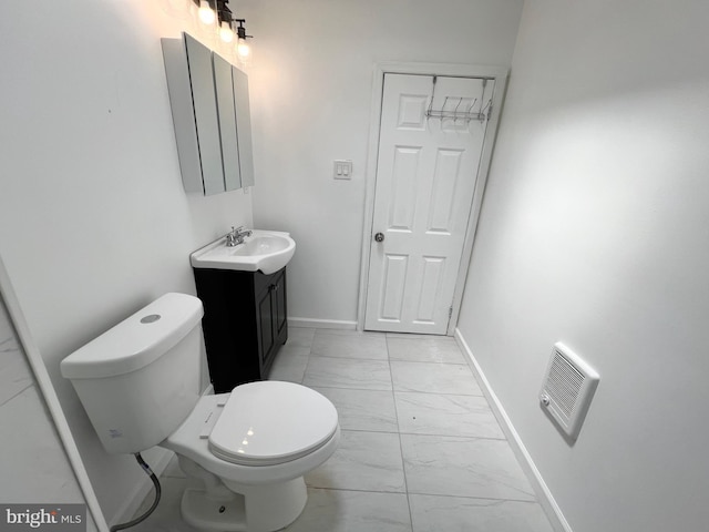 bathroom with toilet and vanity