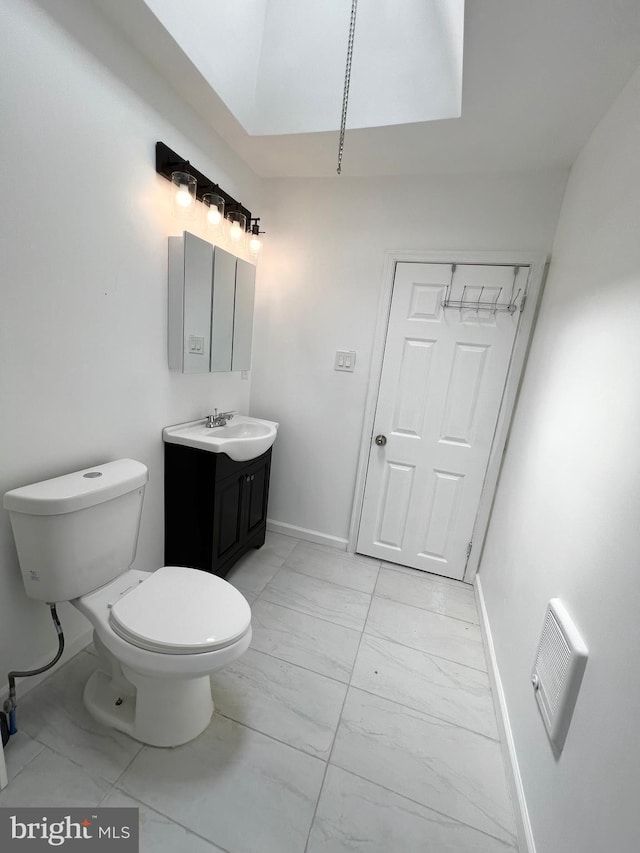 bathroom with toilet and vanity