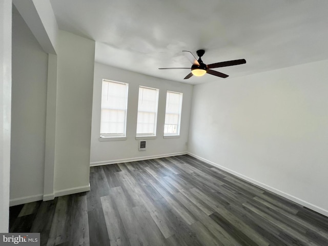 spare room featuring ceiling fan and dark hardwood / wood-style flooring