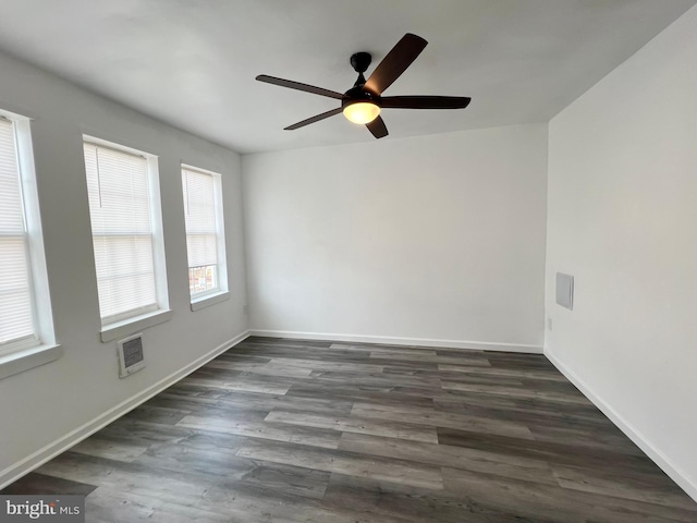 unfurnished room featuring dark wood-type flooring and ceiling fan