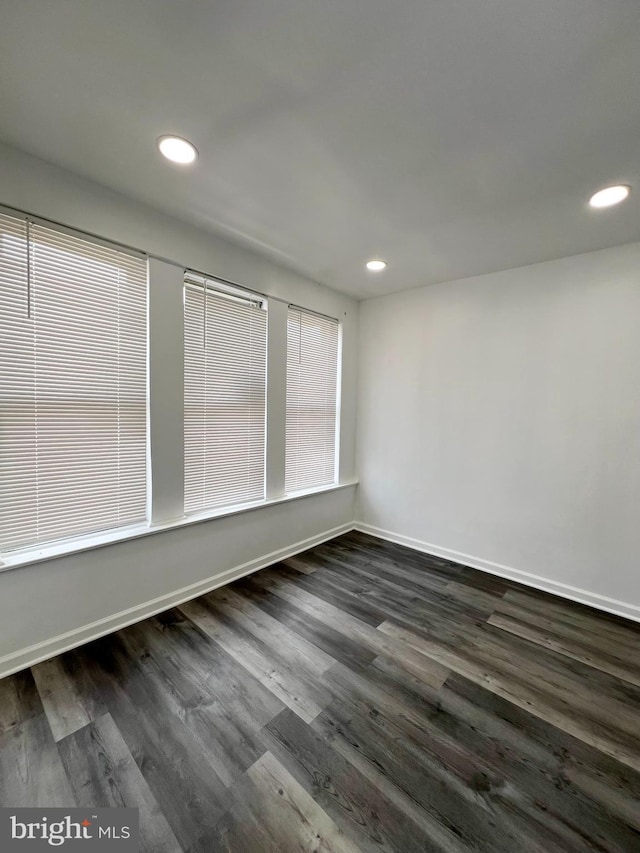 empty room featuring dark hardwood / wood-style flooring