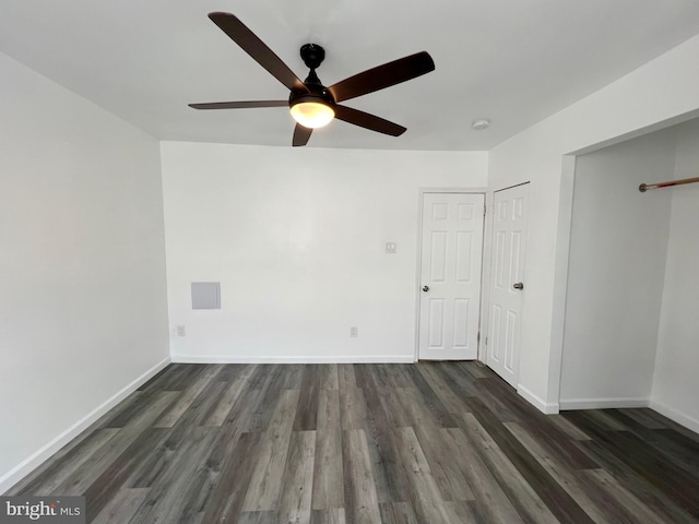 unfurnished bedroom with ceiling fan, two closets, and dark hardwood / wood-style flooring