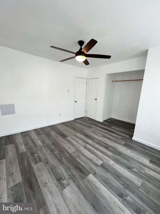 unfurnished bedroom featuring ceiling fan and dark hardwood / wood-style floors