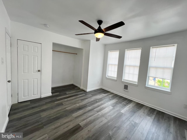 unfurnished bedroom featuring ceiling fan and dark hardwood / wood-style flooring