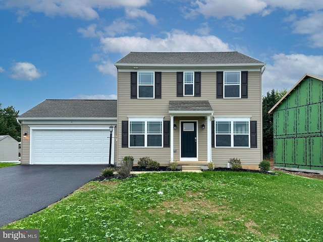 view of front of home featuring a front lawn and a garage