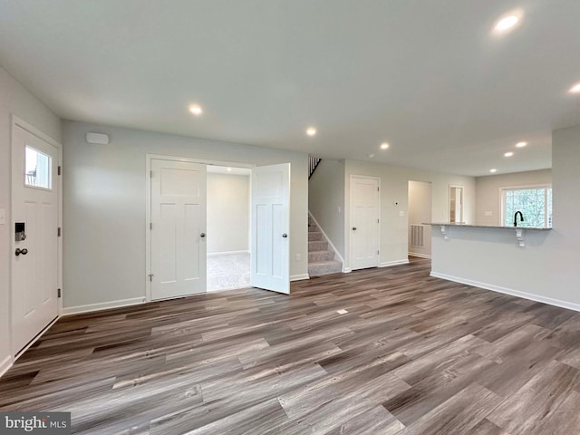 unfurnished living room with hardwood / wood-style floors