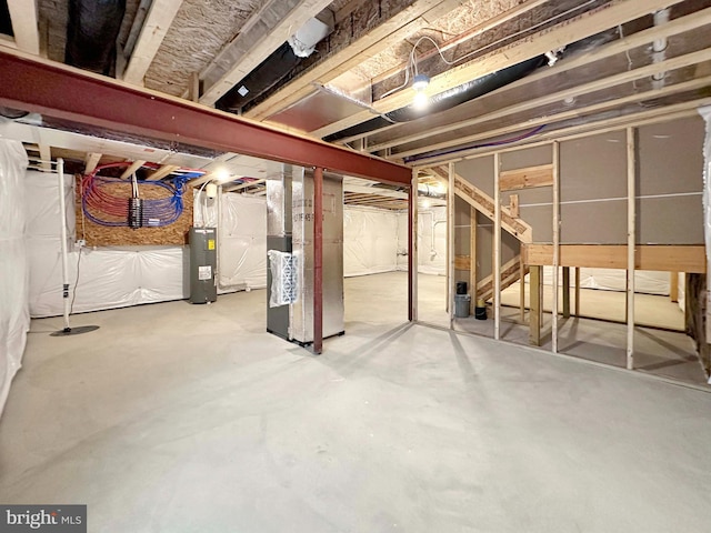 basement with electric water heater and heating unit