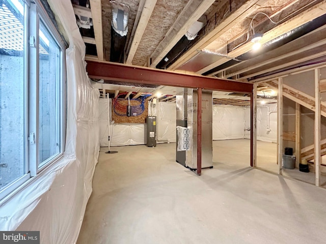 basement with heating unit and electric water heater