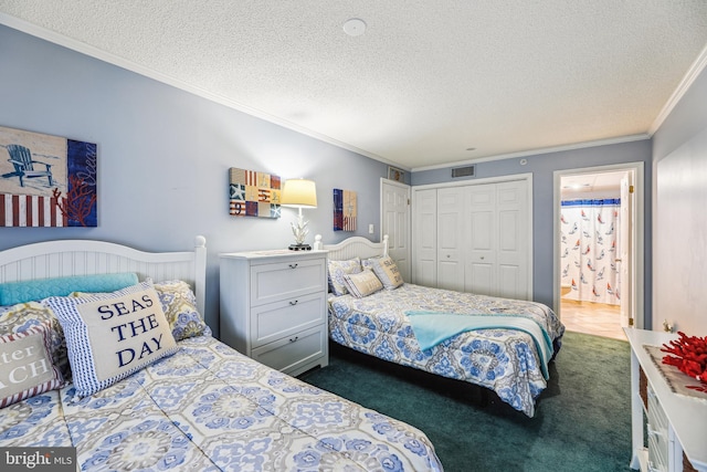 carpeted bedroom featuring a closet, a textured ceiling, and ornamental molding