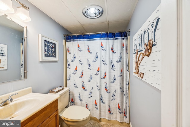 bathroom with toilet, tile patterned floors, vanity, and curtained shower