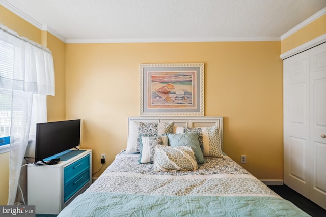 bedroom featuring a closet and crown molding