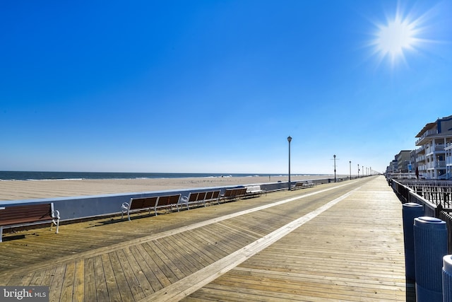 view of dock featuring a water view and central AC