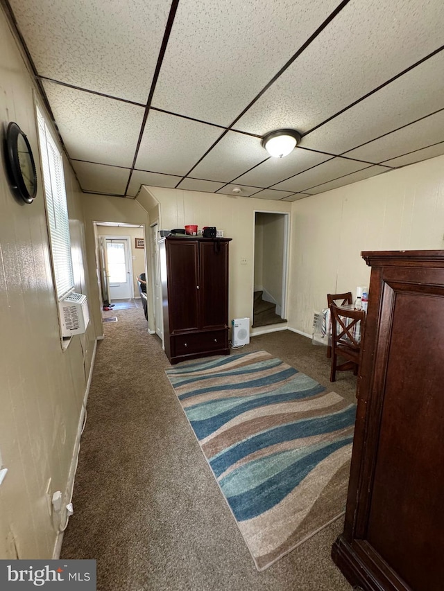 bedroom featuring a drop ceiling and carpet floors