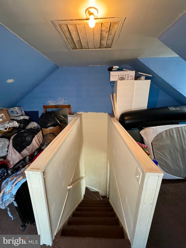 stairs featuring carpet and lofted ceiling