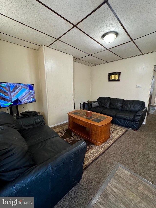 carpeted living room with a paneled ceiling