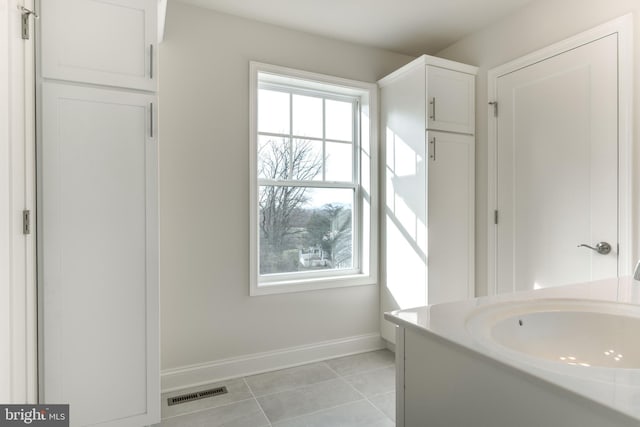 bathroom with vanity and tile patterned flooring