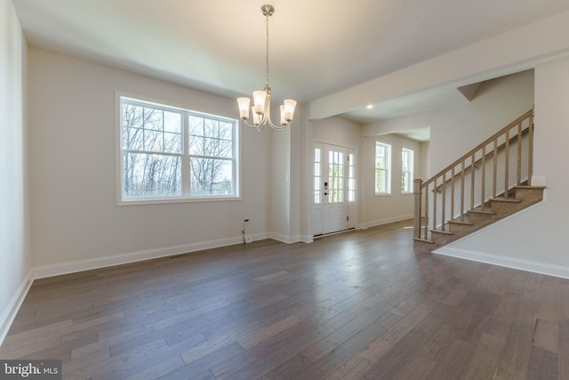 interior space featuring french doors, dark hardwood / wood-style floors, and an inviting chandelier