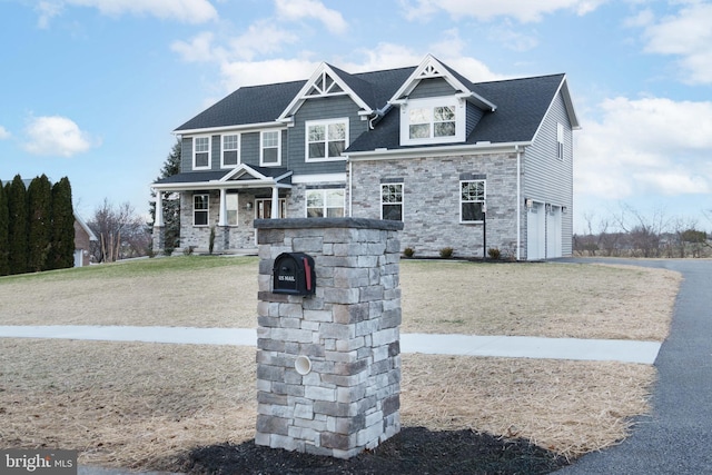 view of front of property with a front lawn and a garage