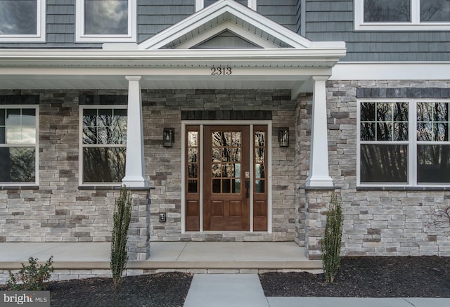 view of exterior entry with a porch