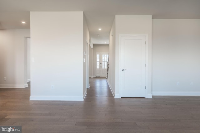 empty room featuring dark hardwood / wood-style flooring and french doors