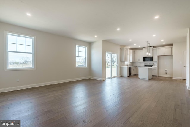 unfurnished living room featuring hardwood / wood-style floors