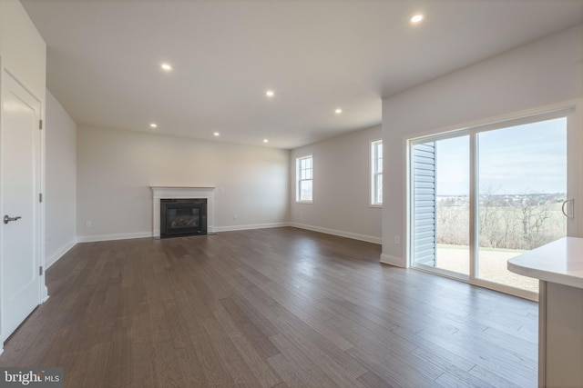 unfurnished living room with dark hardwood / wood-style flooring