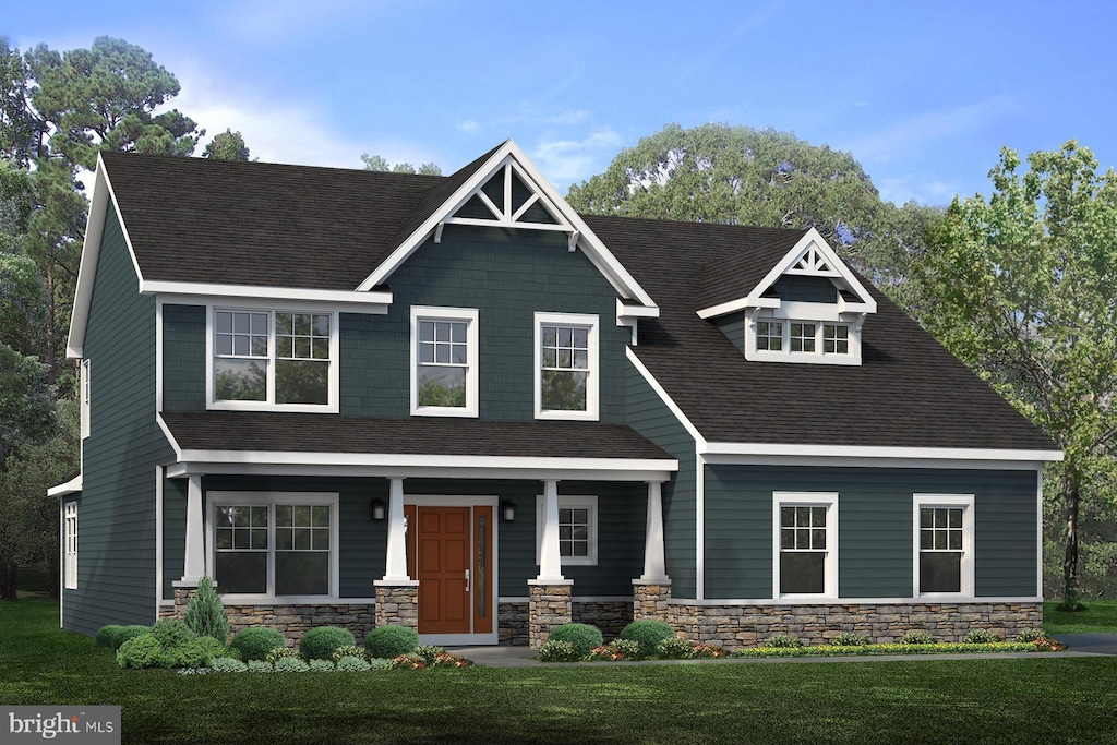 craftsman inspired home with a front lawn