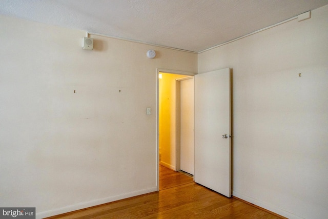 spare room with wood-type flooring