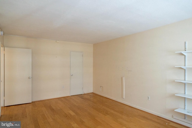 spare room with light hardwood / wood-style flooring