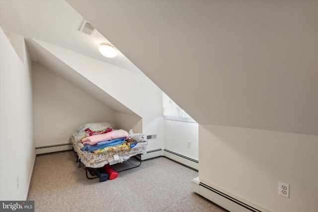 carpeted bedroom with vaulted ceiling and a baseboard radiator