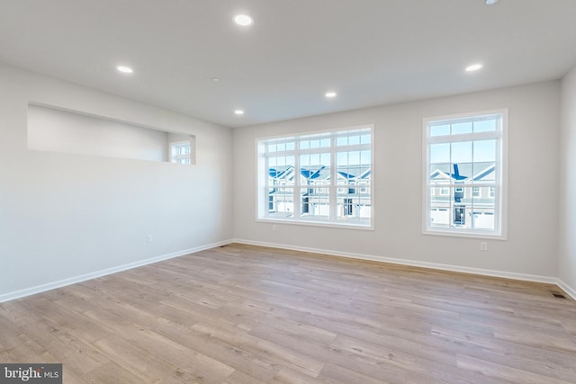 unfurnished room with light wood-type flooring