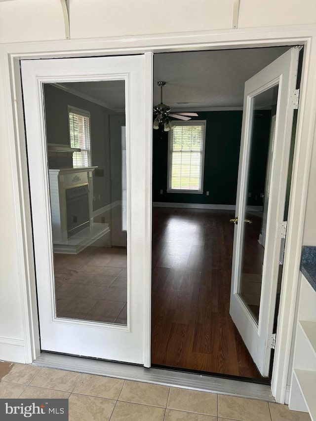 corridor featuring light tile patterned flooring and crown molding