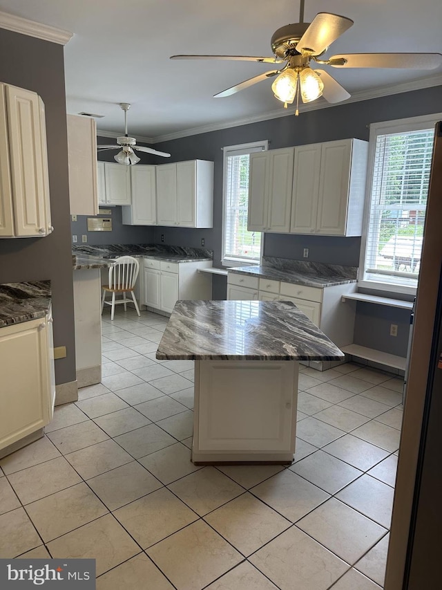 kitchen featuring a kitchen breakfast bar, a center island, and crown molding