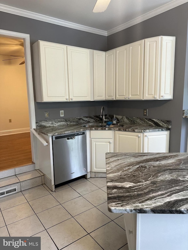 kitchen with light tile patterned floors, dishwasher, ornamental molding, white cabinets, and sink