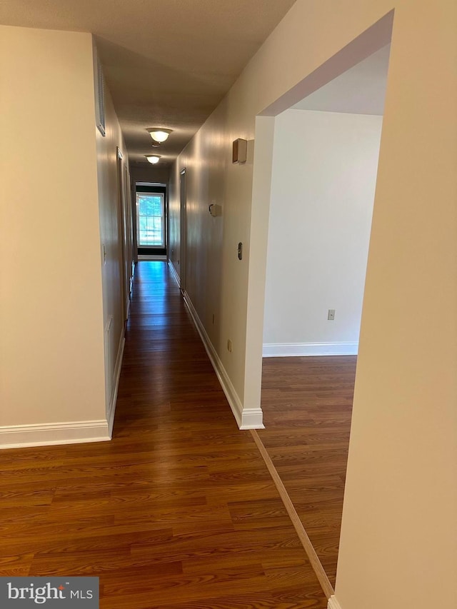 hall with dark hardwood / wood-style floors