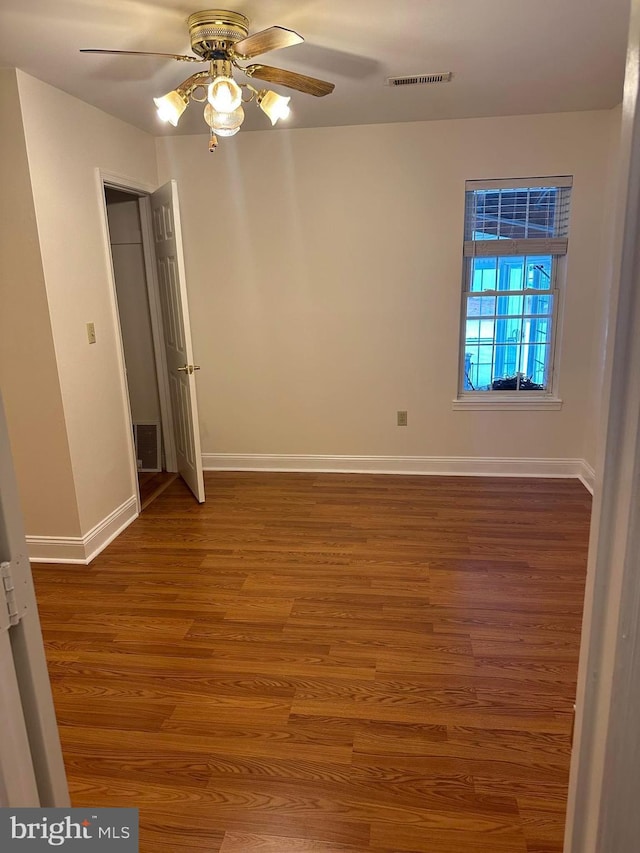 unfurnished bedroom with ceiling fan and dark hardwood / wood-style flooring