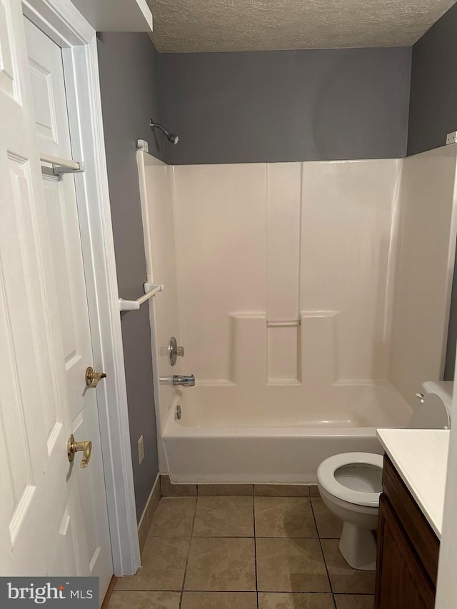 full bathroom featuring tub / shower combination, a textured ceiling, tile patterned floors, vanity, and toilet