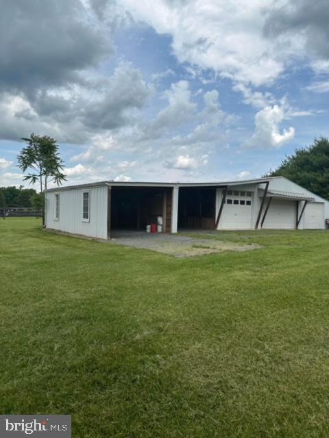 view of outbuilding with a garage and a lawn