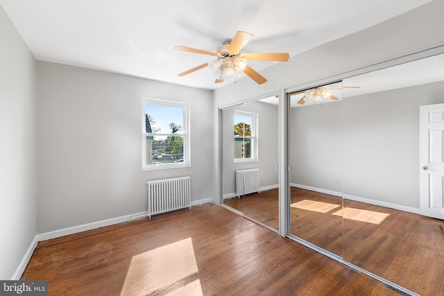 entryway with radiator heating unit, hardwood / wood-style floors, and ceiling fan