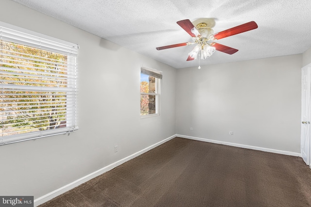 carpeted spare room featuring ceiling fan, a healthy amount of sunlight, and a textured ceiling