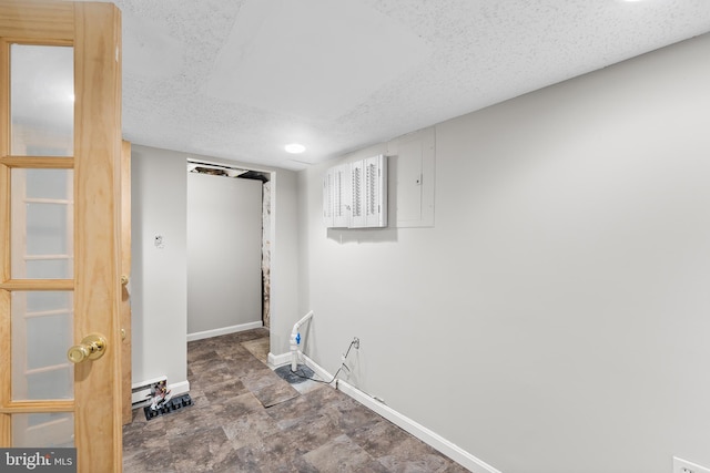 clothes washing area featuring a textured ceiling