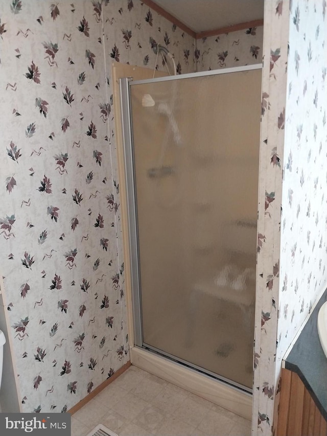 bathroom featuring a shower with door