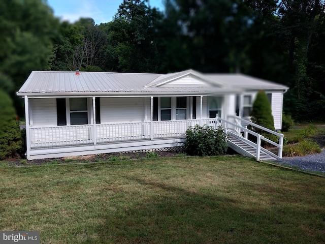 ranch-style house with a front yard and covered porch