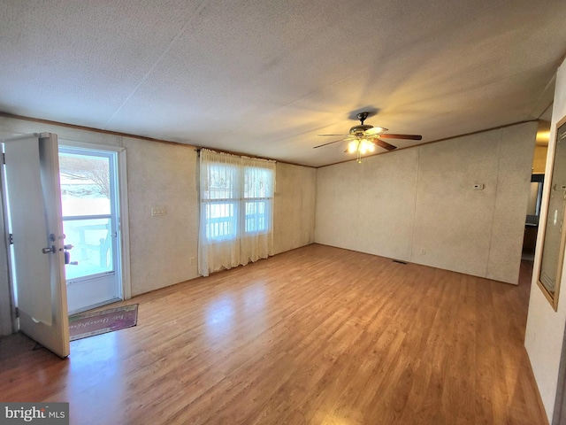 spare room featuring hardwood / wood-style flooring, a textured ceiling, and ceiling fan