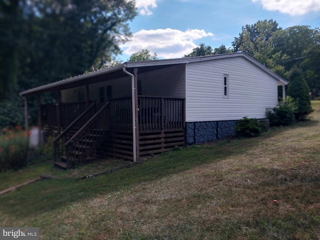 view of side of home featuring a yard