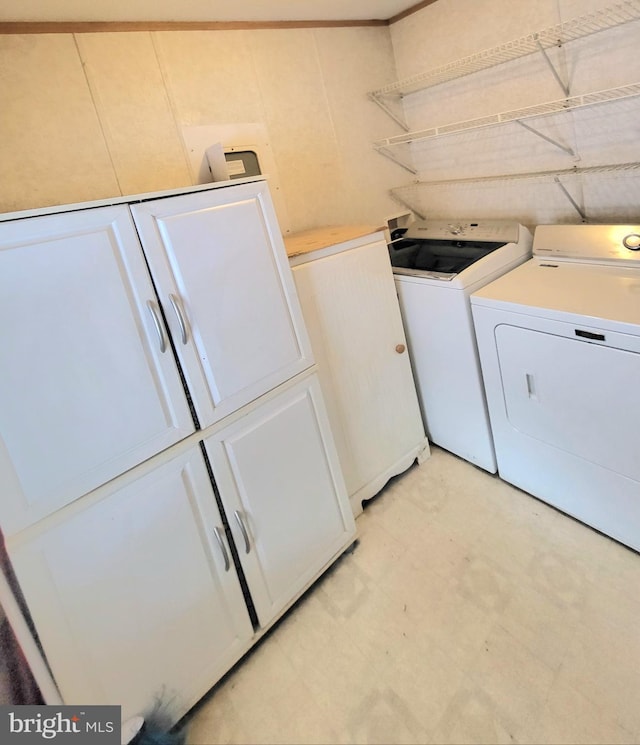 laundry area with cabinets and washer and clothes dryer