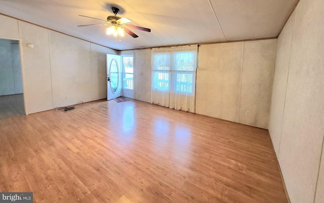 spare room with light hardwood / wood-style flooring and ceiling fan