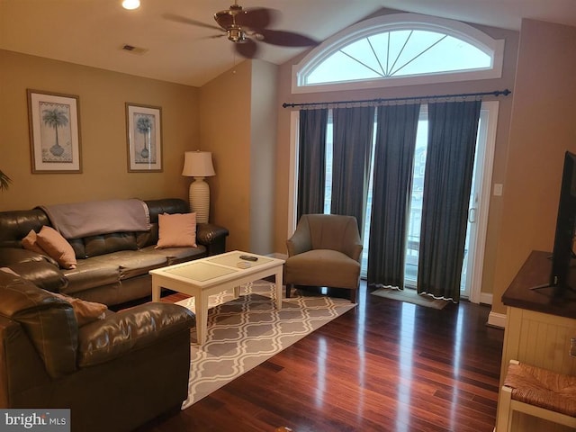 living room with ceiling fan, lofted ceiling, and dark hardwood / wood-style flooring