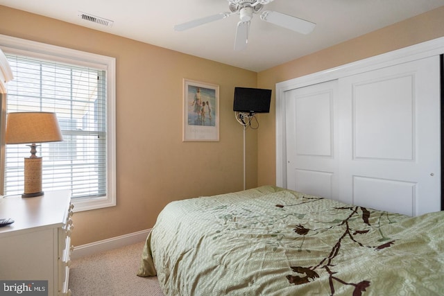 carpeted bedroom with a closet and ceiling fan